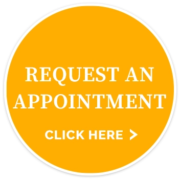 Yellow circular graphic displaying the text "REQUEST AN APPOINTMENT" and "CLICK HERE >".